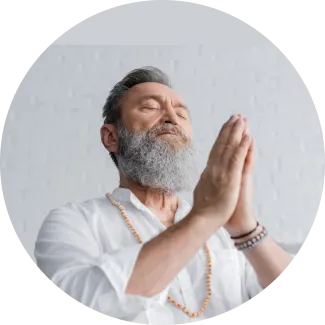 Man meditating with hands in prayer position, embodying the theme of rediscovering abilities and inner healing